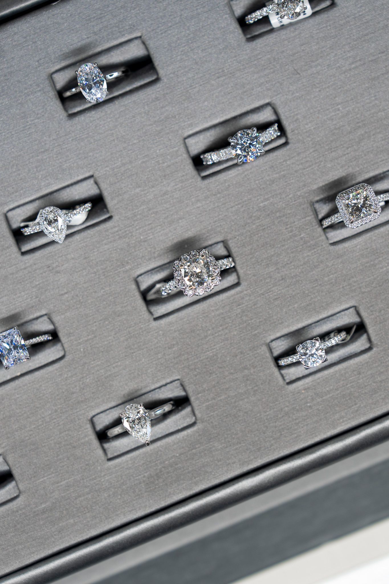 Silver rings displayed on a gray padded jewelry tray.