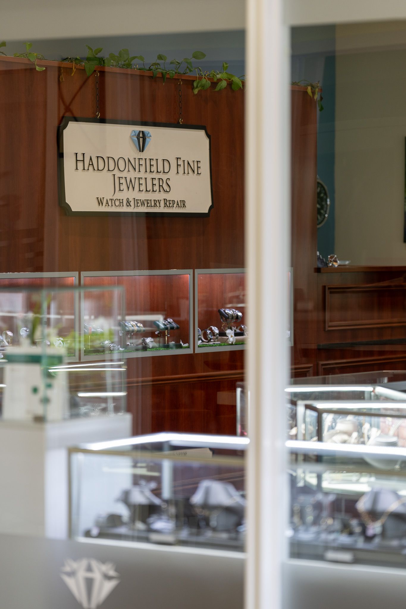 Jewelry store display case with rings and a sign reading “Huntington Park Jewelers”.