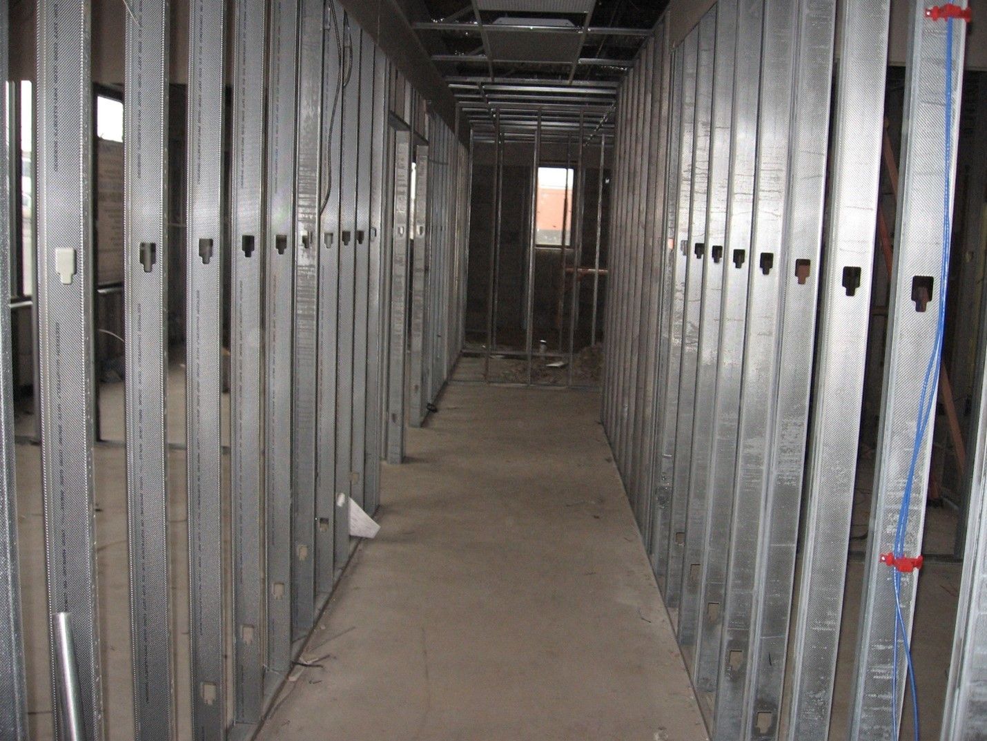 A long hallway with metal walls and a window