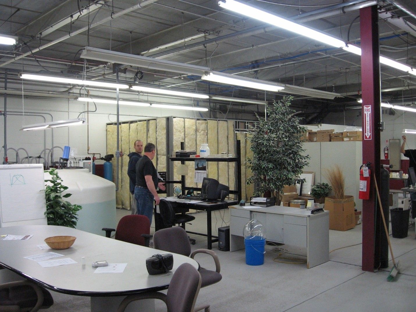 A man standing in a room with a fire extinguisher