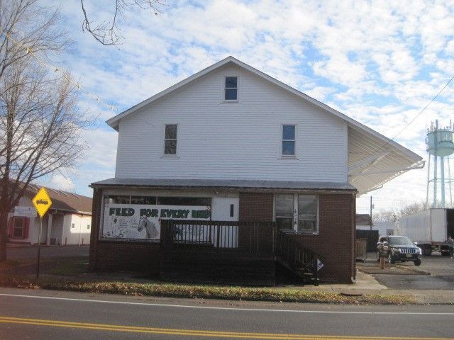 A building with a sign for the feed mill restaurant that says feed for every man