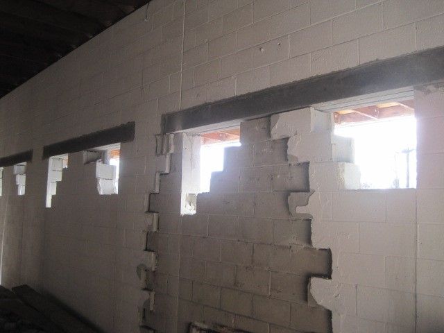 A brick wall with a few windows in it