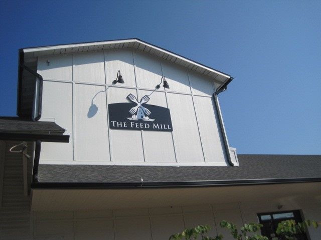 A sign on the side of a building says the feed mill