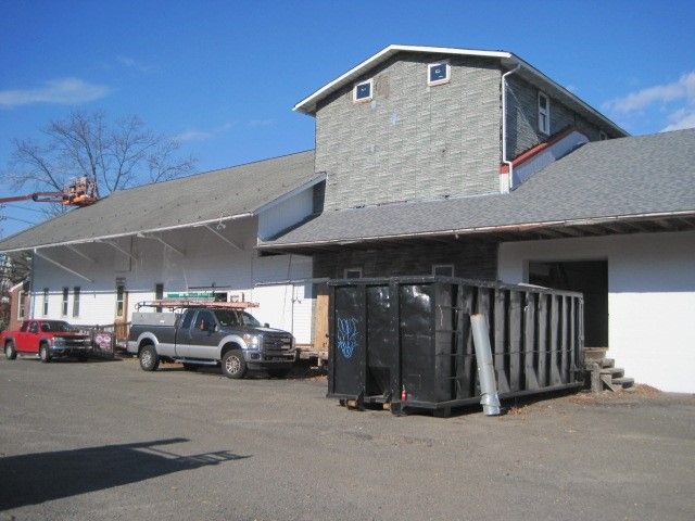 A truck is parked in front of a large building