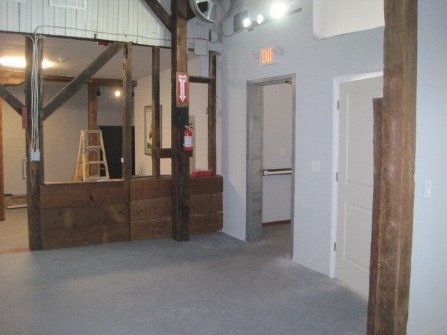An empty room with a red exit sign on the wall
