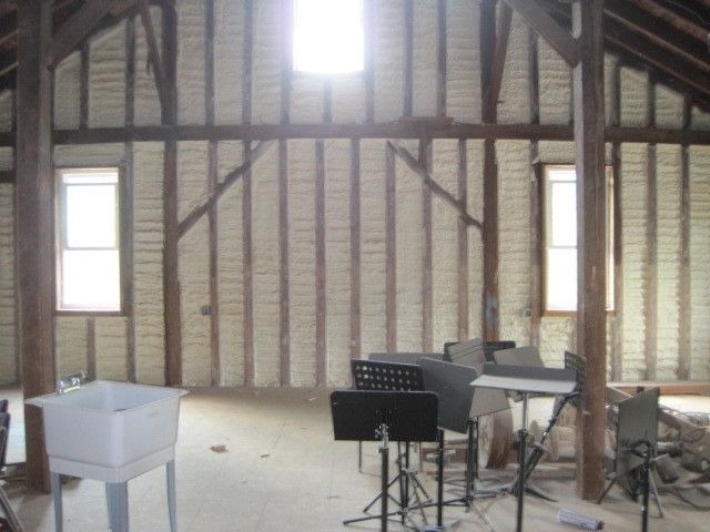 A large room with a sink and musical instruments in it