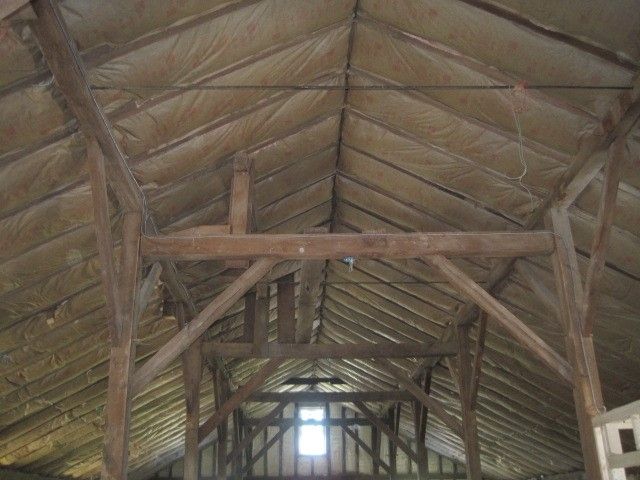 The ceiling of a building with a window in the middle