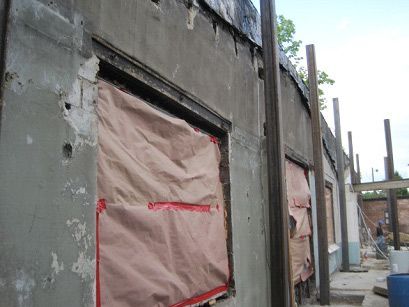 A building that is being remodeled with a lot of windows