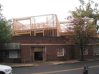 A brick building with a roof that is being built