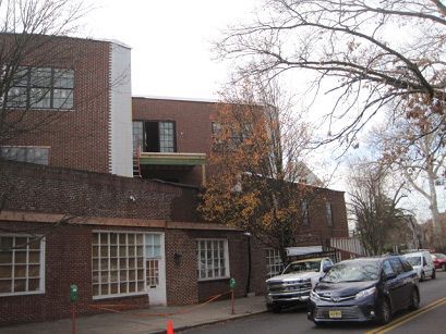 A brick building with cars parked in front of it