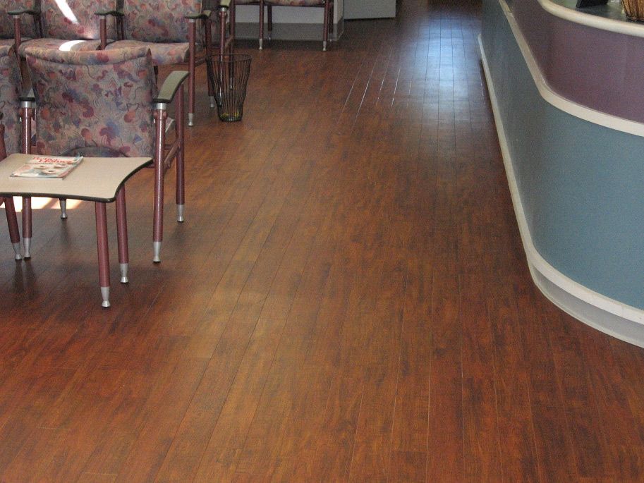 A waiting room with wooden floors and chairs