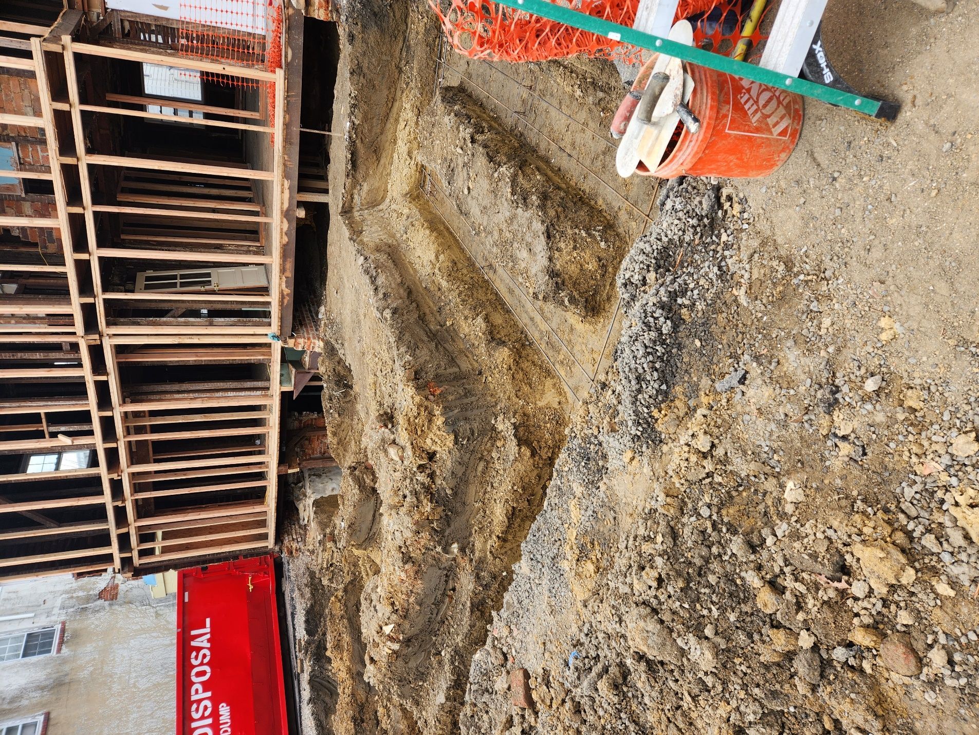 A red dumpster with the word disposal on it.