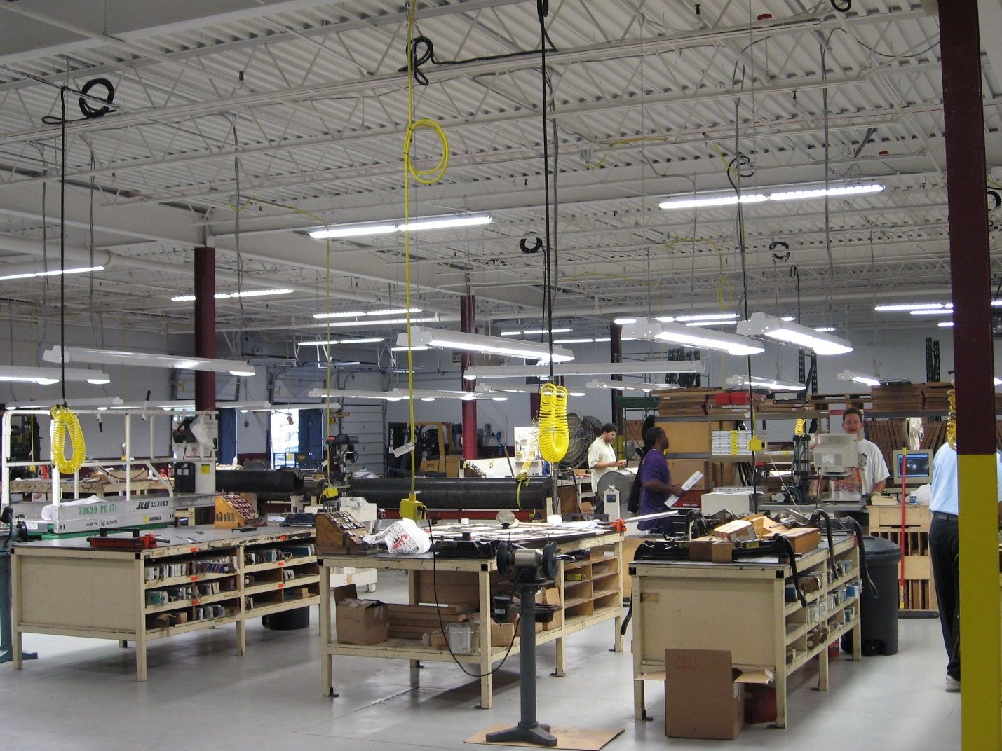 A large warehouse with lots of tables and shelves.
