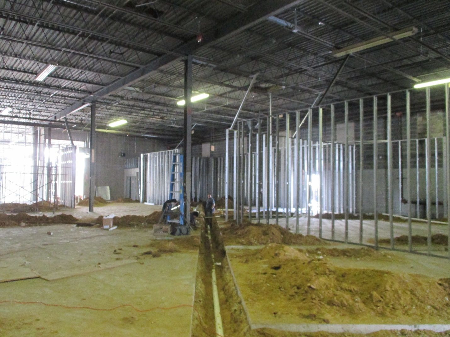 A large building under construction with a lot of metal frames.