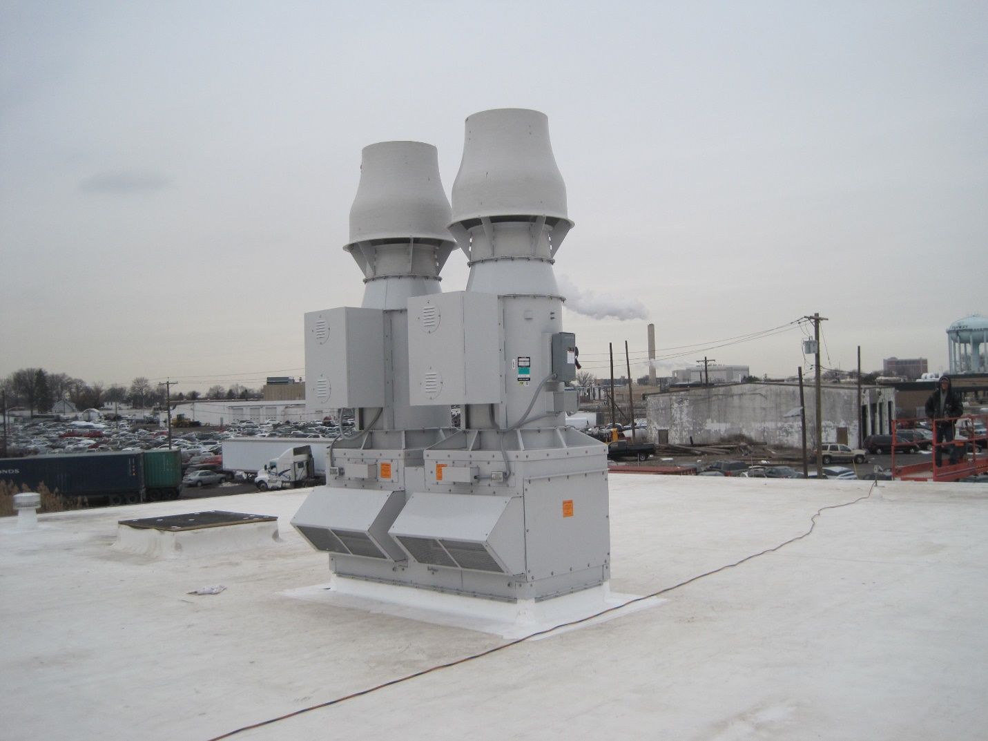 A white roof with a lot of exhaust pipes on it.