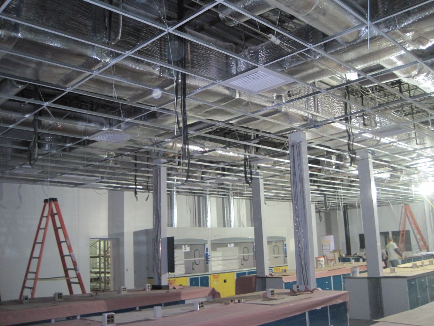 A large room with a ladder in the middle of it.