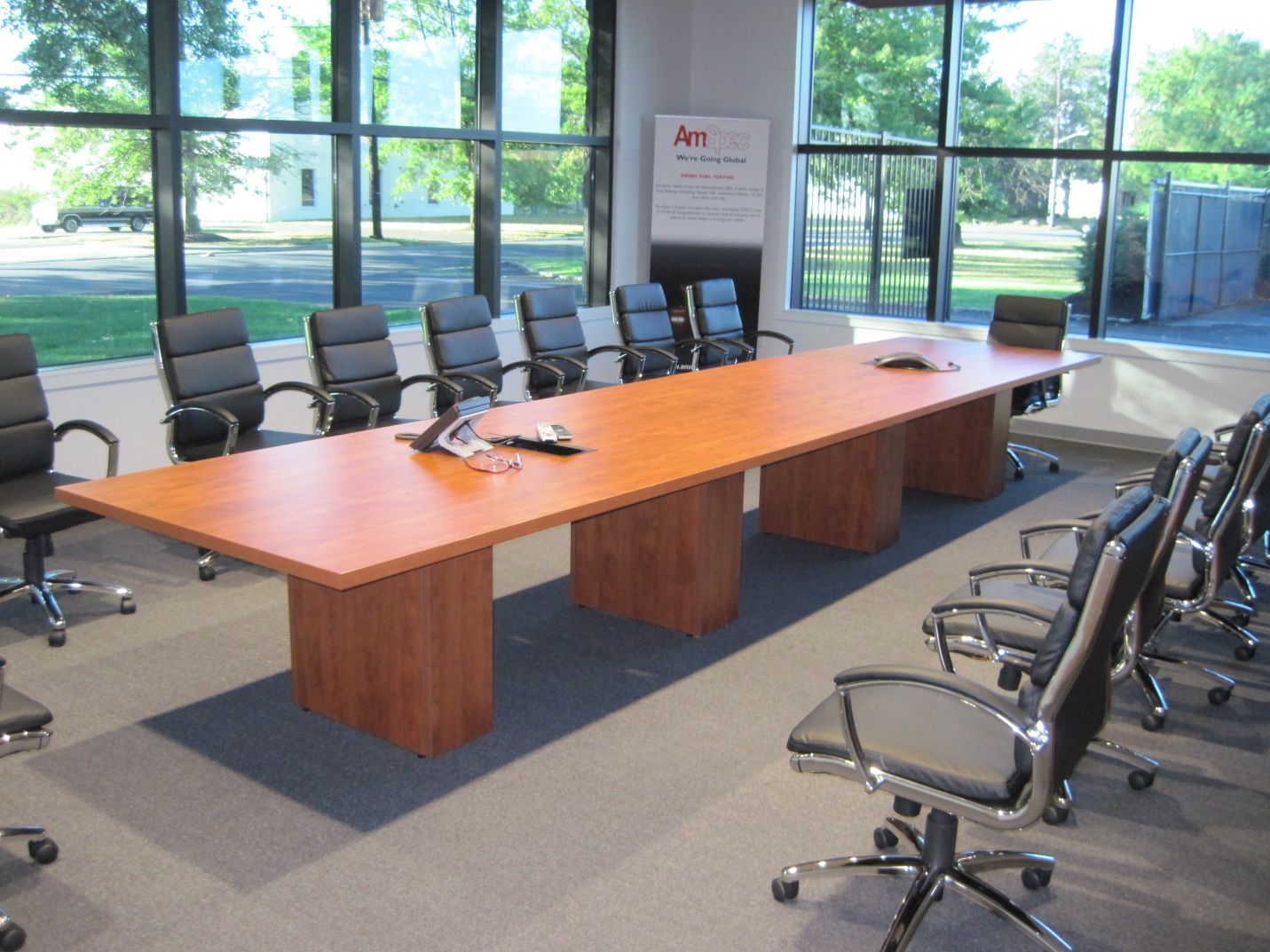 A conference room with a long wooden table and chairs.