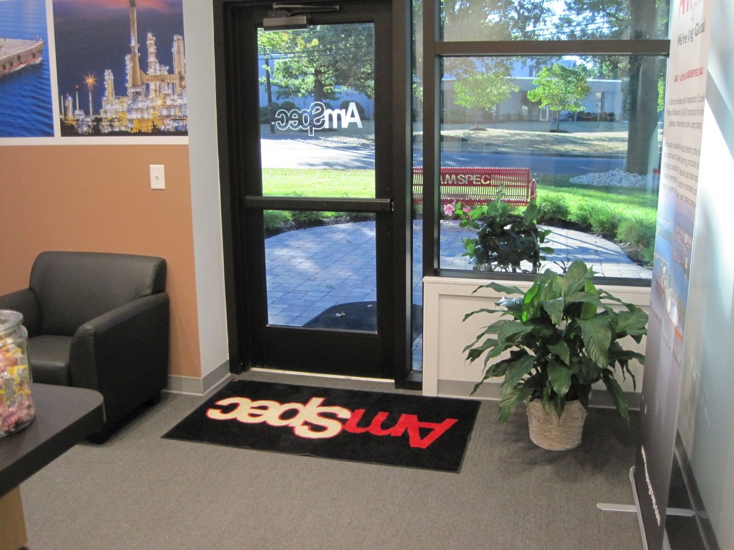 A waiting room with a rug that says amspec on it.