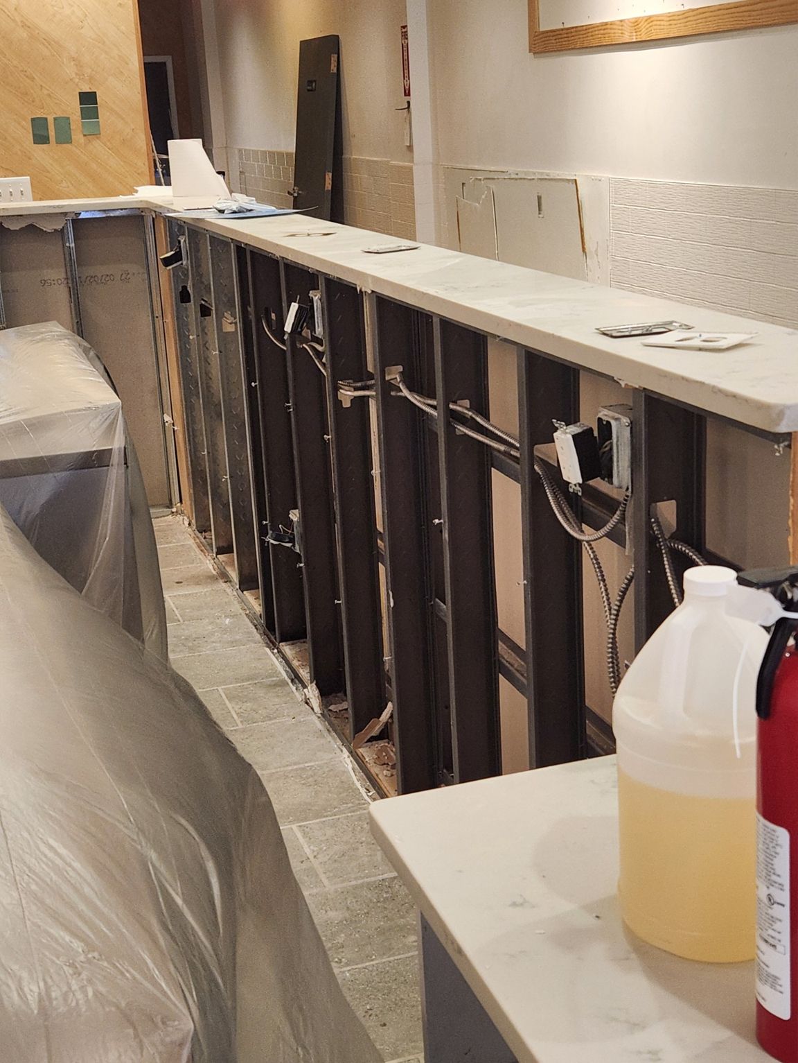 Bar under construction with exposed framing and wiring.