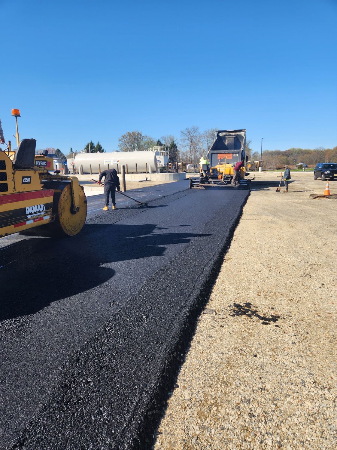 Asphalt road paving in progress.
