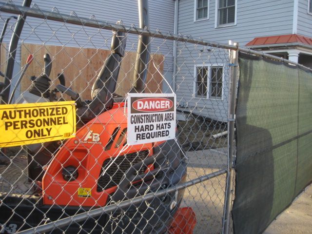 A chain link fence with a sign that says authorized personnel only.