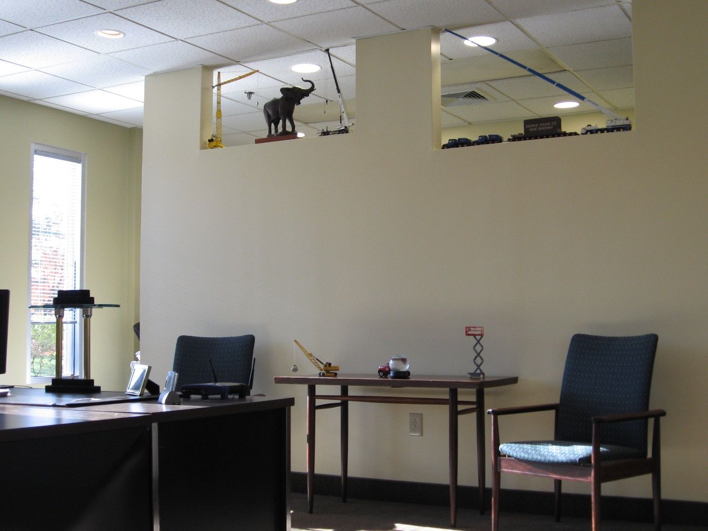 An office with a statue of an elephant on the ceiling.