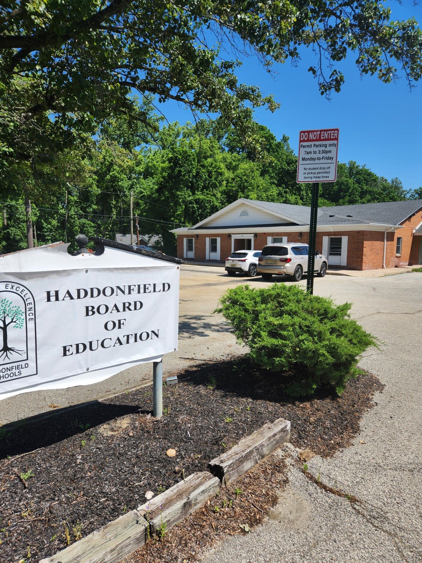 A sign for the Haddonfield board of education is in front of a building.