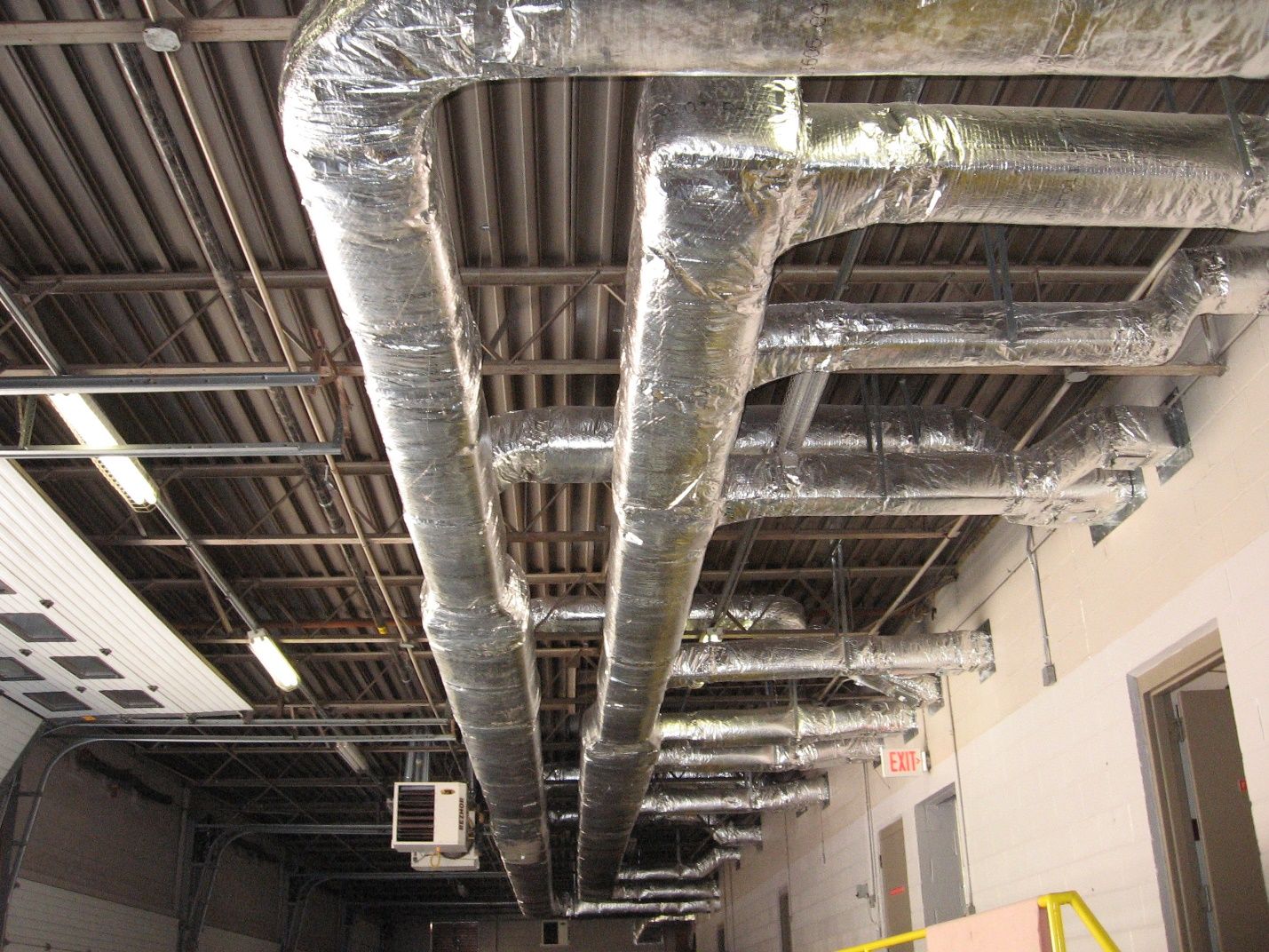 A building with a lot of pipes hanging from the ceiling.