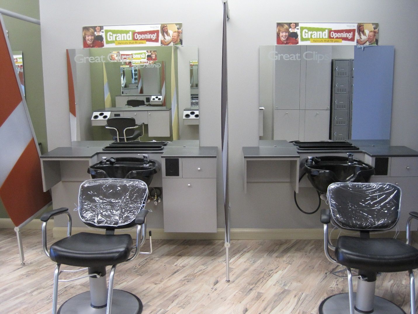 A barber shop with two chairs and two sinks.