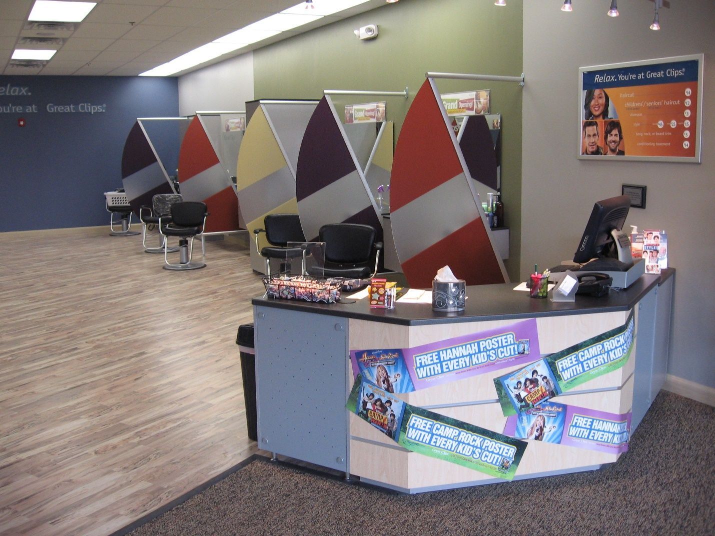 A dental office with a desk and chairs and a sign that says