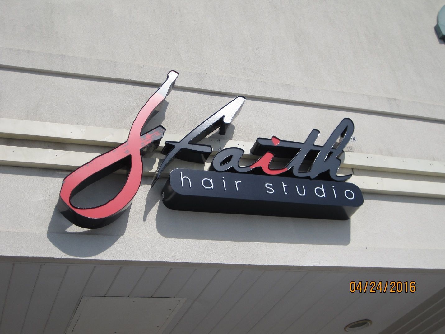 A sign that says faith hair studio on it.