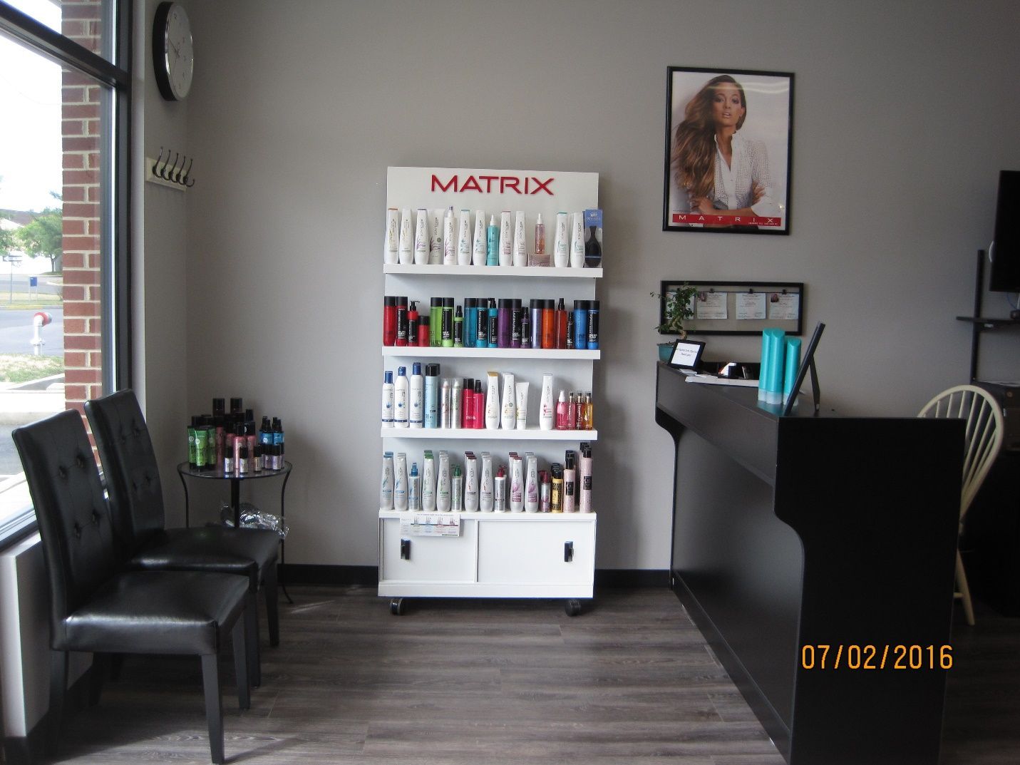 A waiting room with a display of matrix hair products.