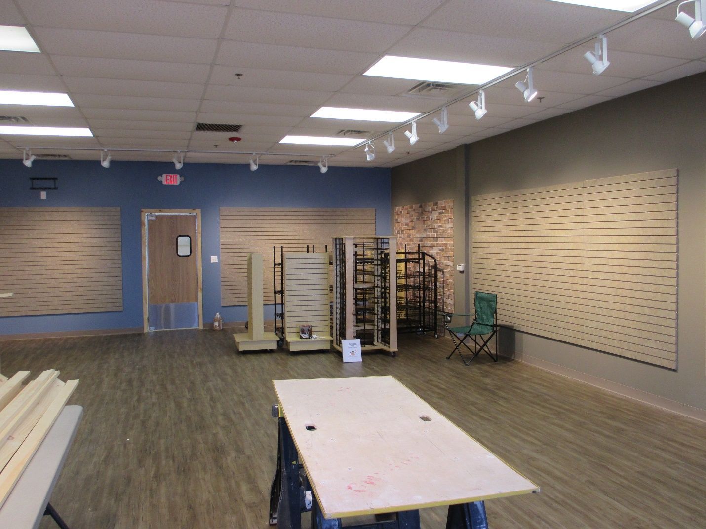 An empty room with a table and chairs in it.