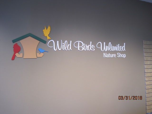 A sign for wild birds unlimited nature shop.
