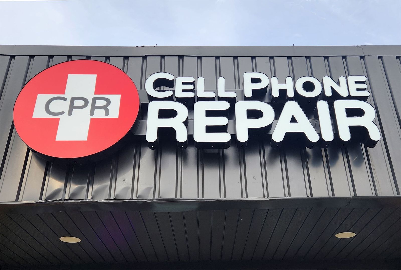 A Cell Phone Repair sign on the side of a building