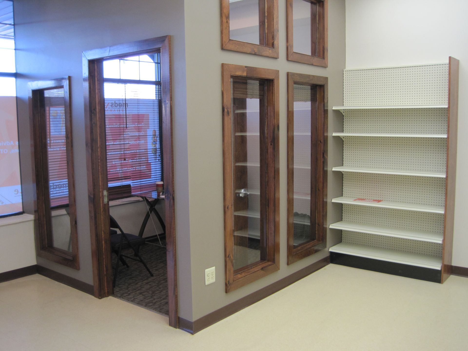 A room with a lot of windows and shelves