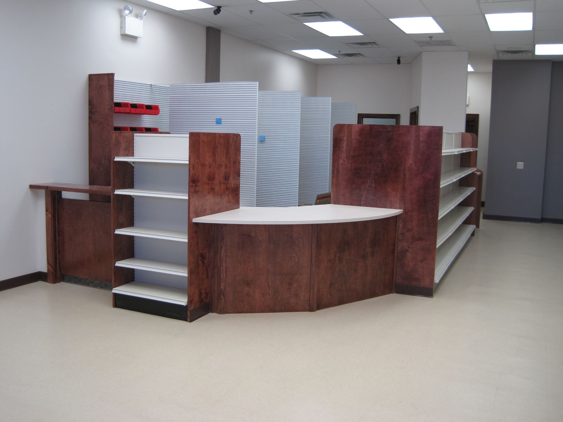 An empty store with a wooden counter and shelves