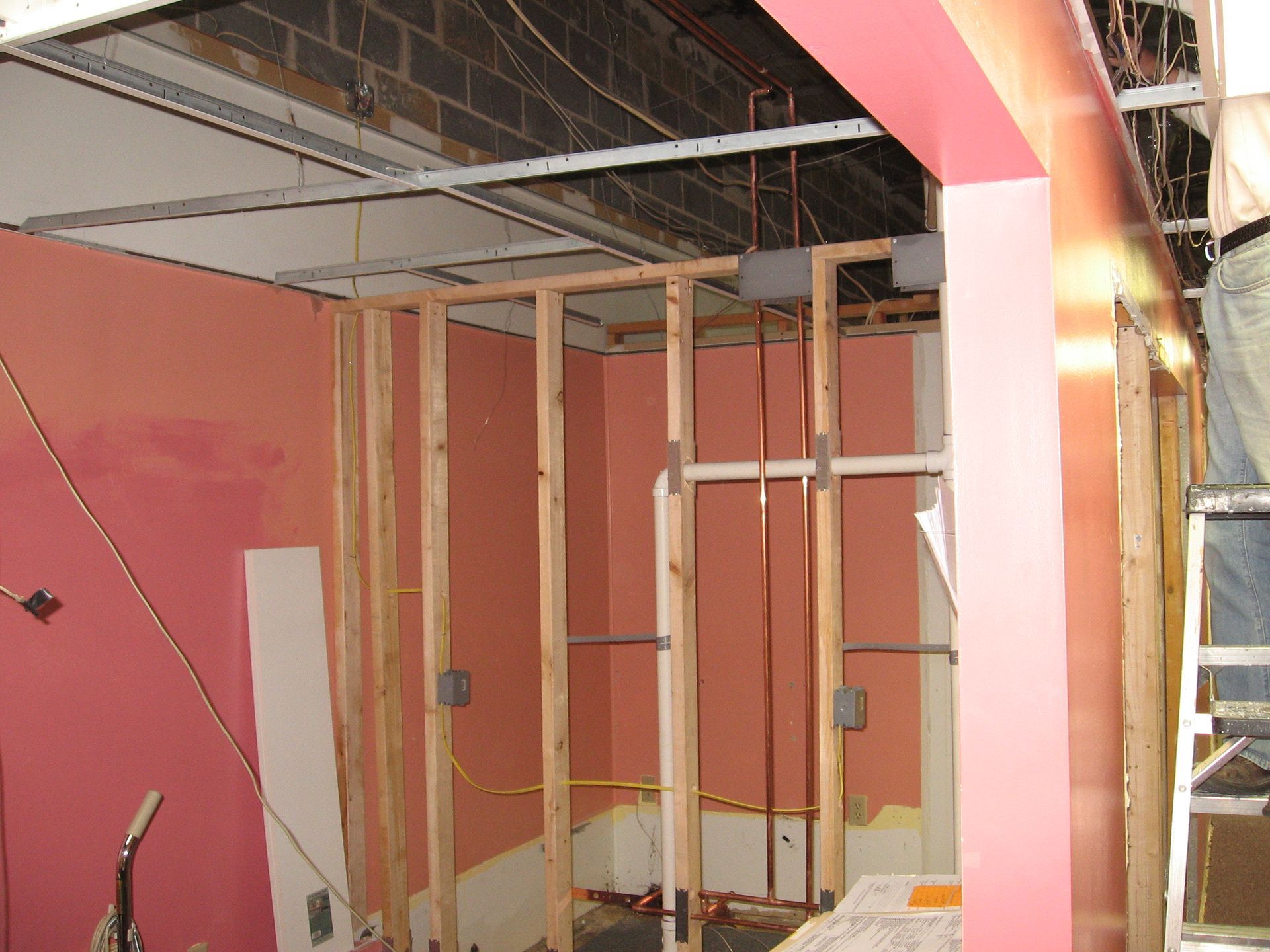 A room that is being remodeled with a pink wall
