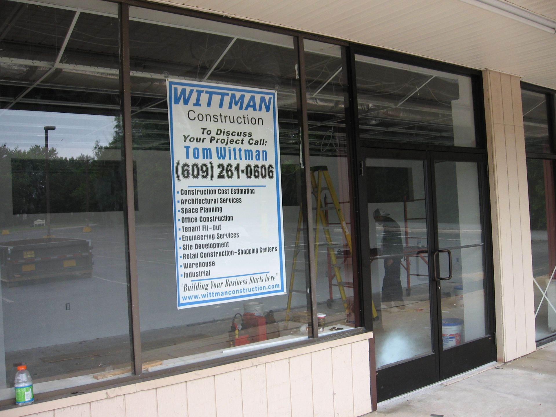 A sign in a window for Wittman Construction