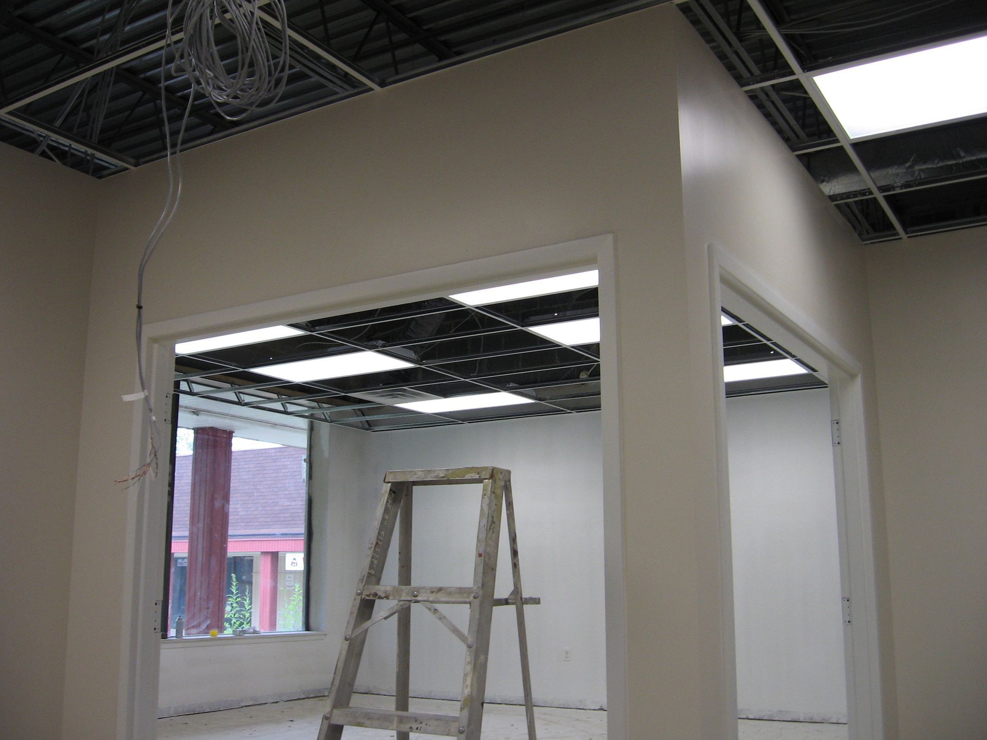 An empty room with a ladder in the middle of it