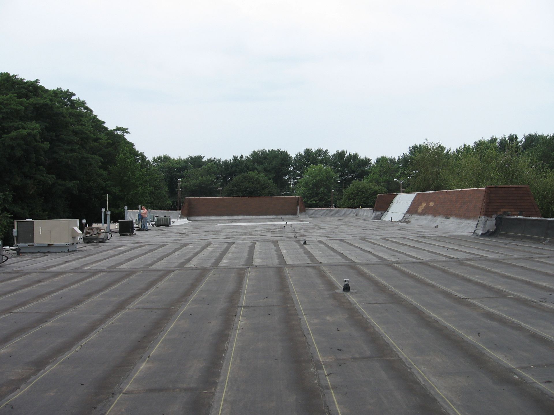 The roof of a building with trees in the background
