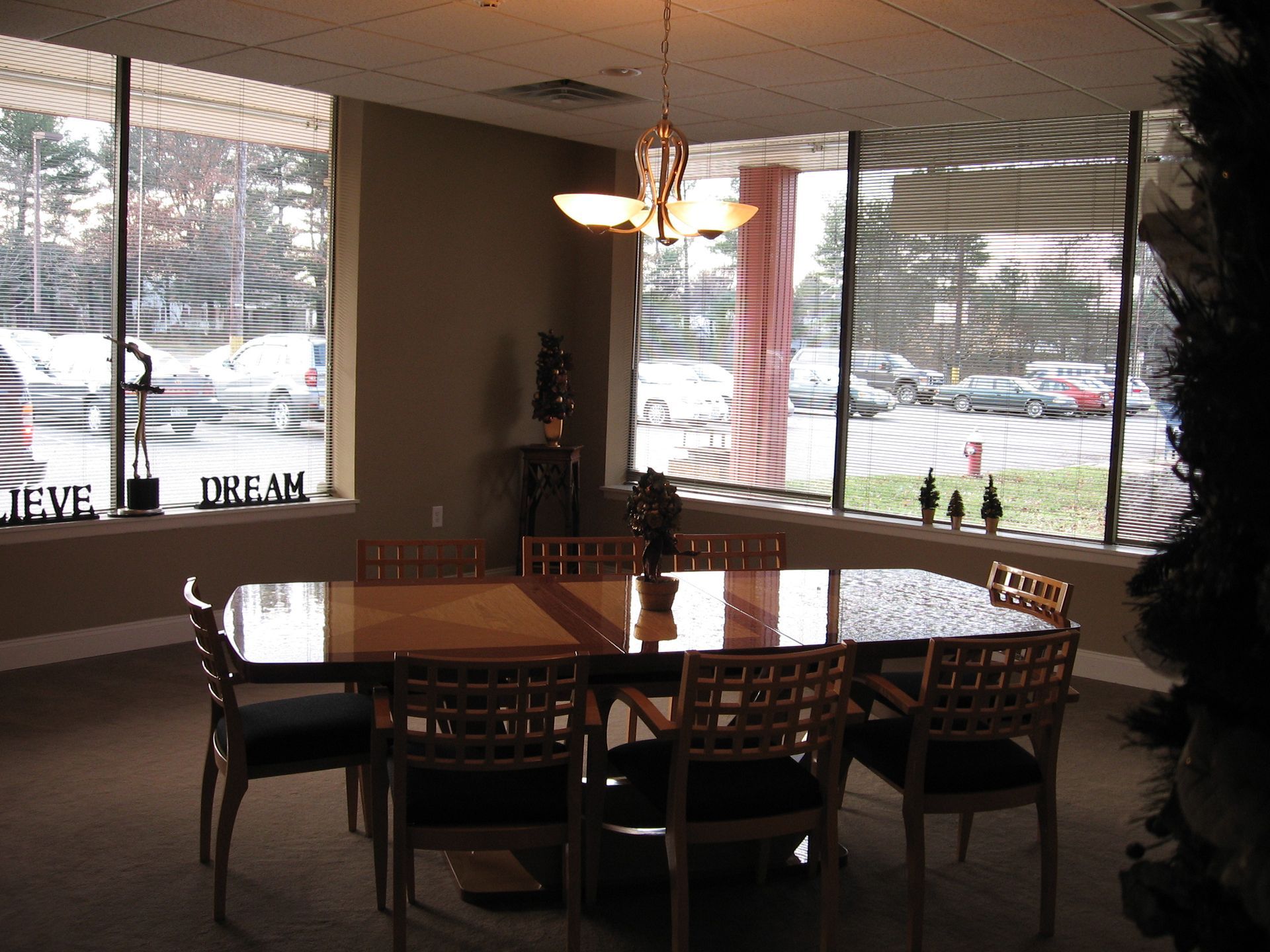 A room with a table and chairs and a sign that says believe