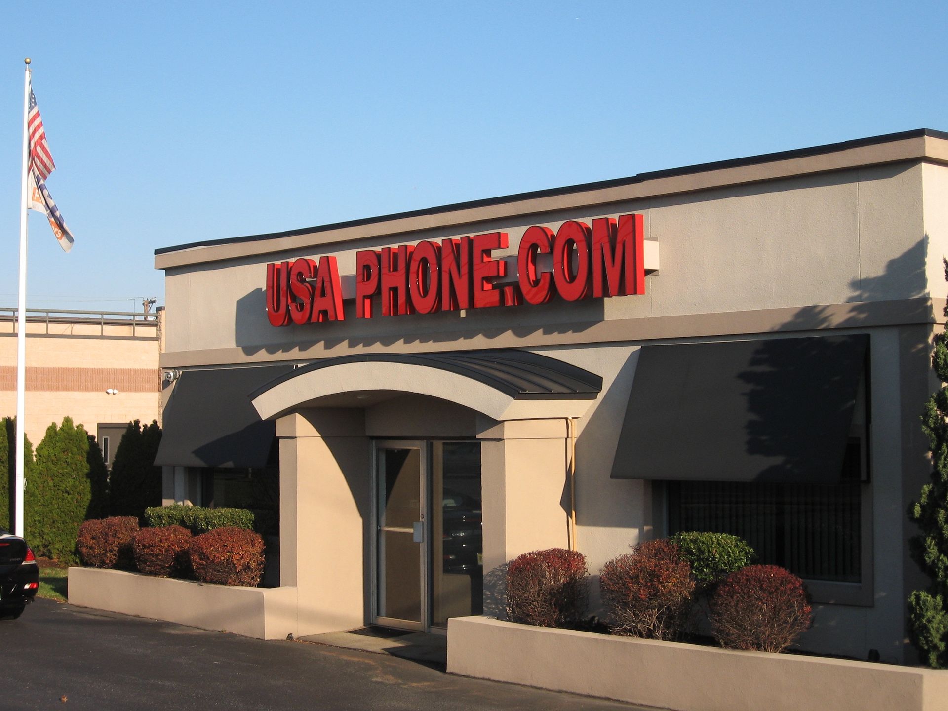 The front of a building that says USA PHONE.COM
