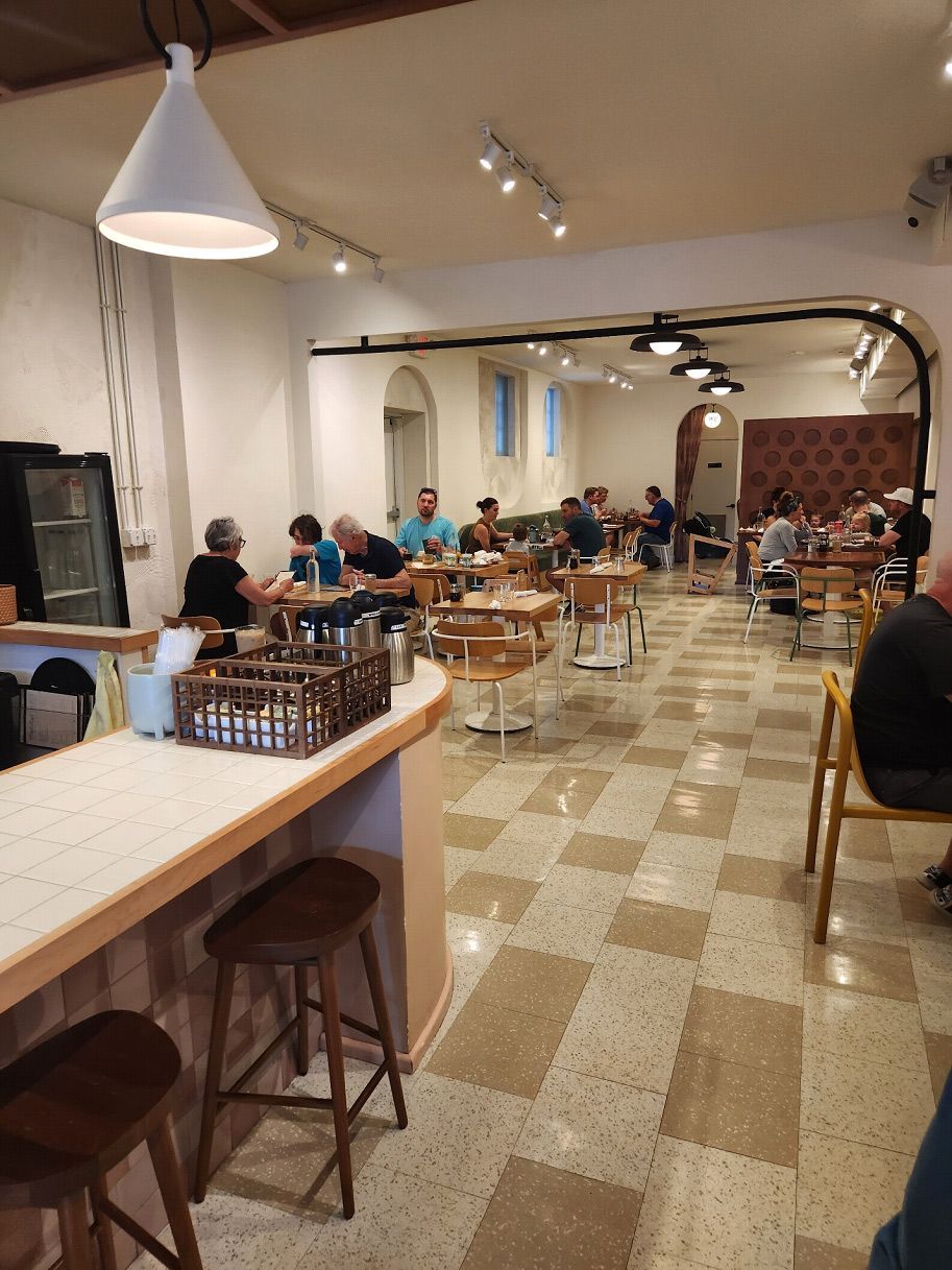 A group of people are sitting at tables in a restaurant.