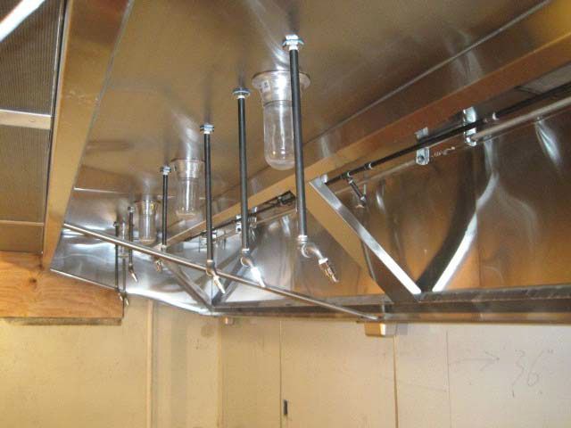 Cafe lift project with a stainless steel hood hanging from the ceiling