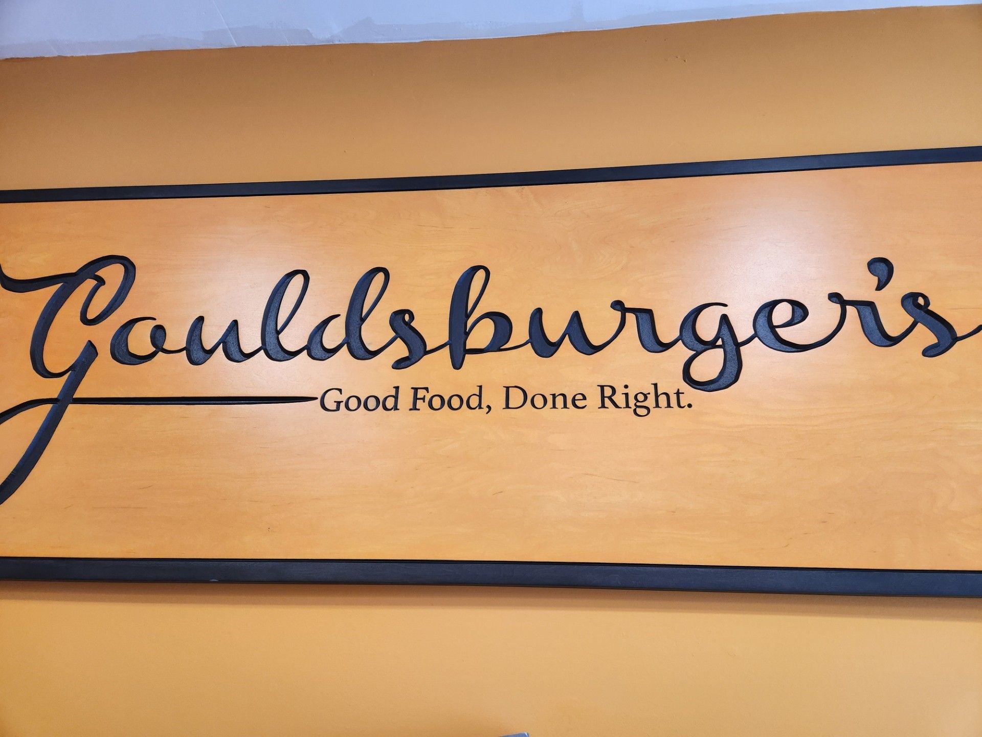 A wooden sign that says Gouldsburger's on it