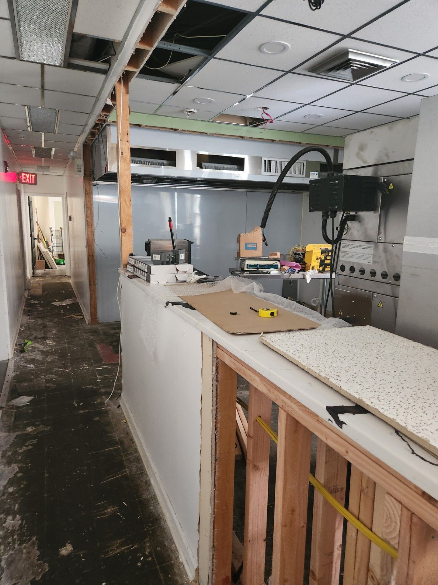 A kitchen is being remodeled in a long hallway.