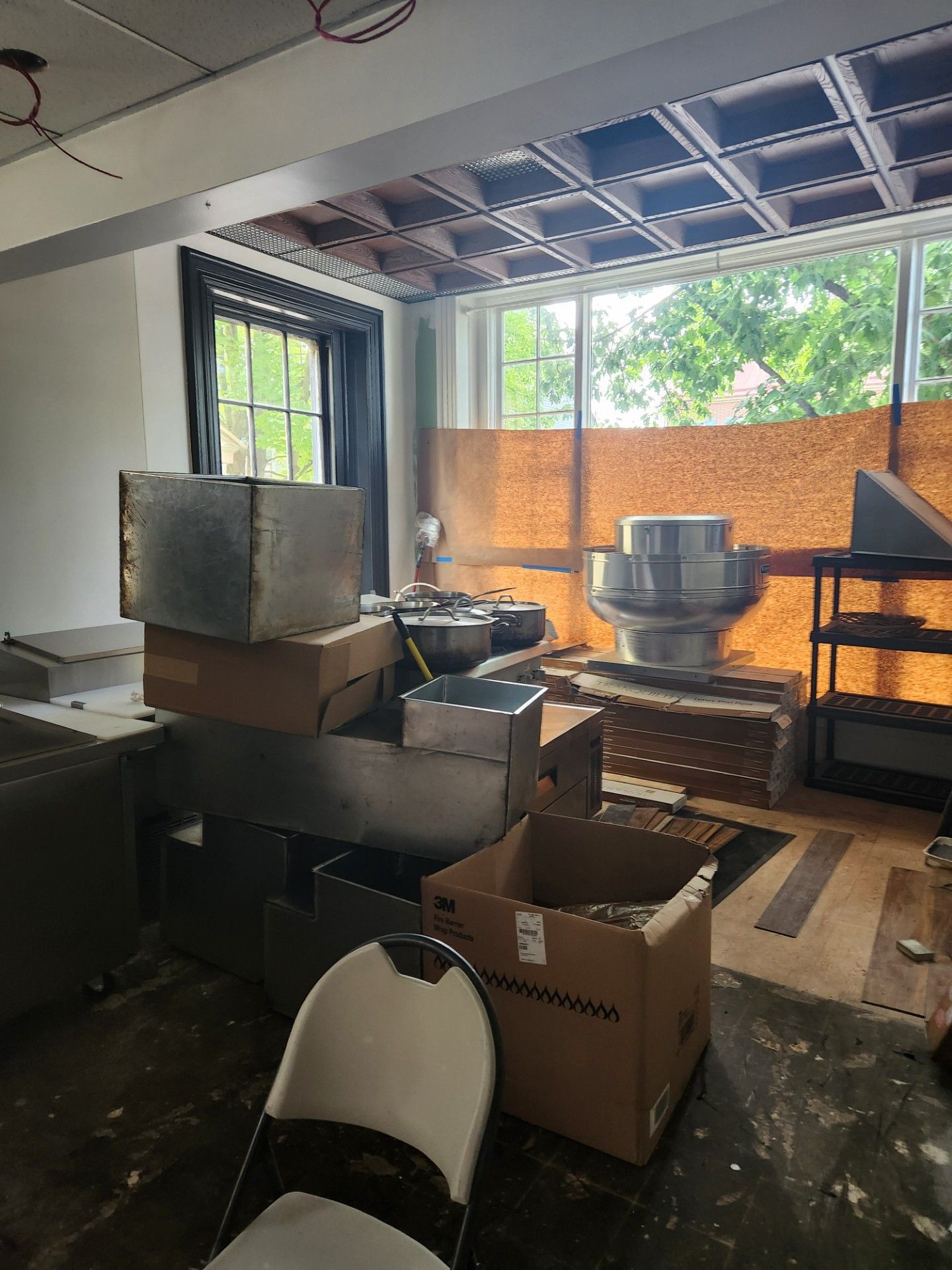 A room with a lot of boxes and chairs in it