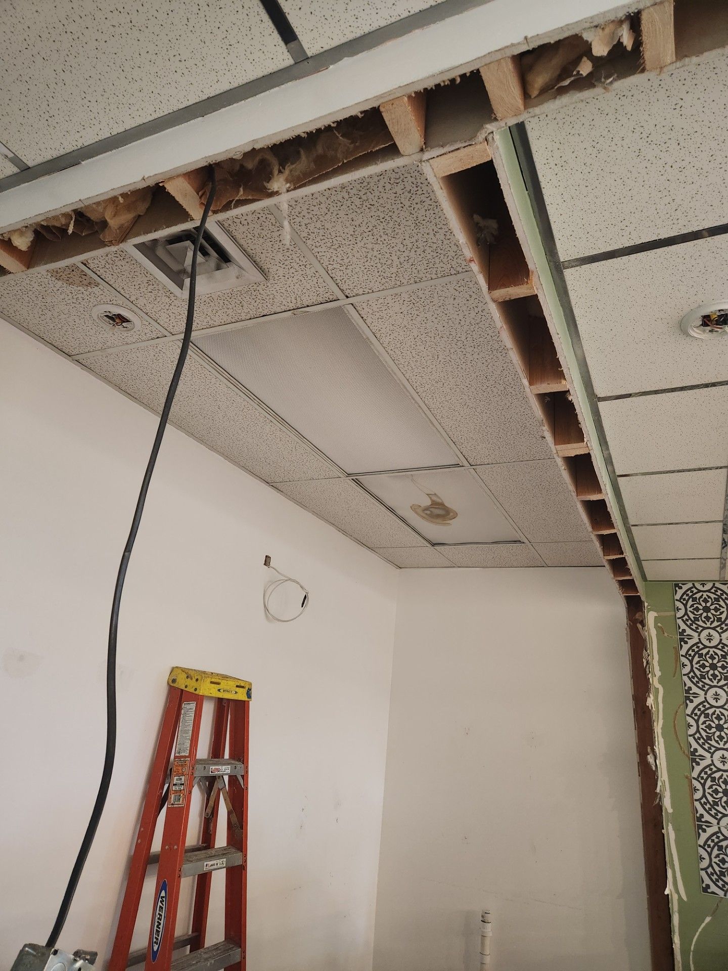 A ladder is hanging from the ceiling of a room