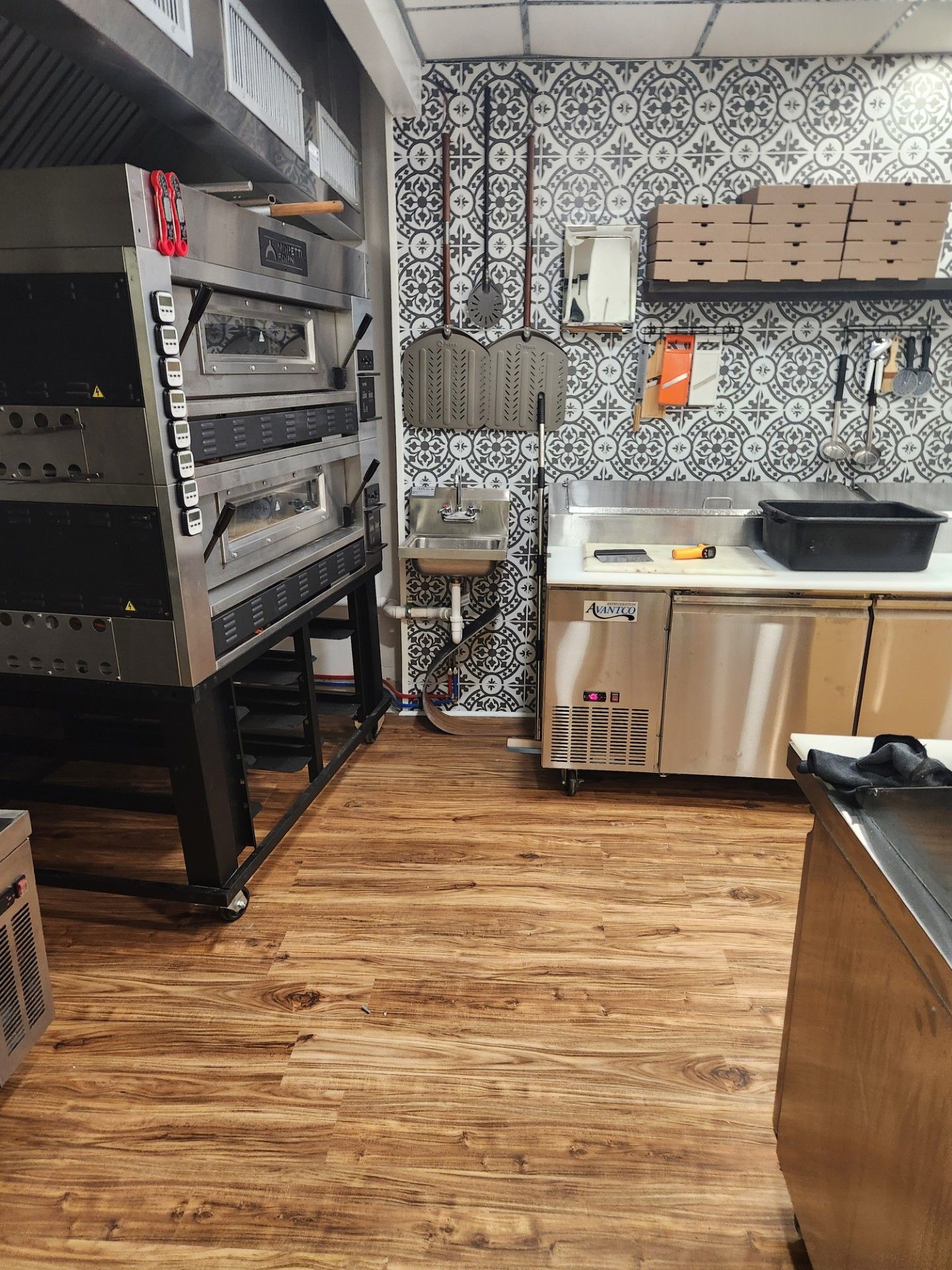 A kitchen with a lot of appliances and a sink.